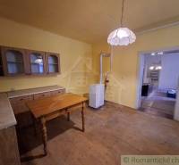 Konyha családi házban bútorokkal és lámpával, fa dekorációjú padlóval.