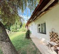 Családi ház Krivosúd-Bodovkán hagyományos homlokzattal, padkával és fával a kertben.