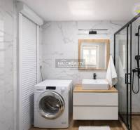 Fürdőszoba mosógéppel, zuhanyzóval, mosdóval és fa dekoros padlóval egy 4 szobás lakásban.