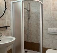 Fürdőszoba WC-vel, zuhanyzóval és mosdóval egy családi házban, csempével burkolva.