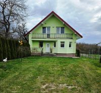 Zöld családi ház Klokočovban verandával és rendezett kerttel.