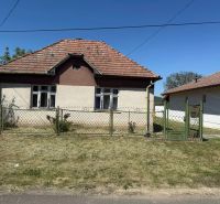 A Honti családi háznak ferde teteje van és fém kerítéssel van körbekerítve.