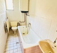 Fürdőszoba családi házban káddal, mosdóval és WC-vel.