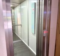 Lift fényes padlóval egy kétszobás lakásban, fehér falak, megvilágított mennyezet.