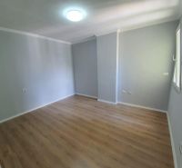 Világos szoba fa mintázatú padlóval a Nyaraló apartmanban.