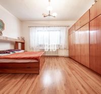 Hálószoba családi házban ággyal, szekrénnyel és fa dekorációjú padlóval.
