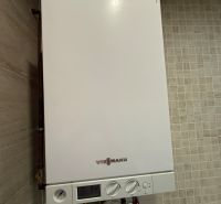 A Viessmann márkájú kondenzációs kazán egy kétszobás lakás belsejében, bézs csempéken.