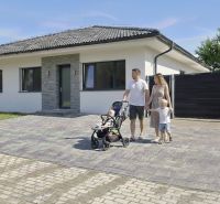 Családi ház Hôrka nad Váhom-ban, családdal a kövezett felhajtón.