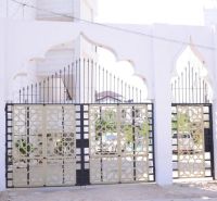 Bejárati kapu egy kétszobás lakásnál a Mbweni utcában, Zanzibárban, dekoratív fém elemekkel.