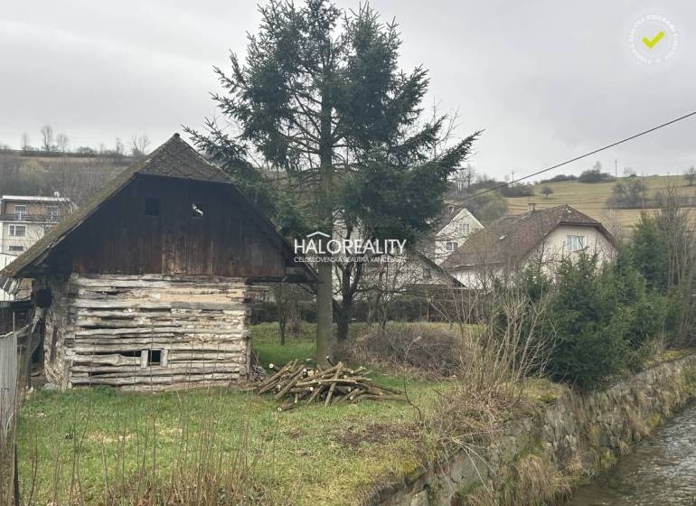 Faház a patak mellett, fákkal körülvéve, fű a telken - vidéki élet.