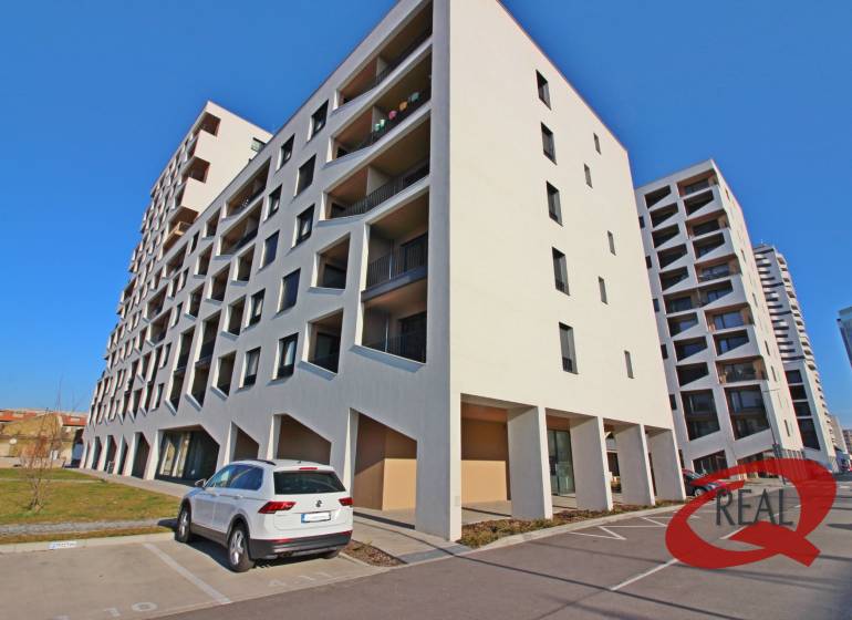 Épület parkolóval Pozsony-Petržalka városrészben, a Závodu Matador utcában, parkoló autóval.