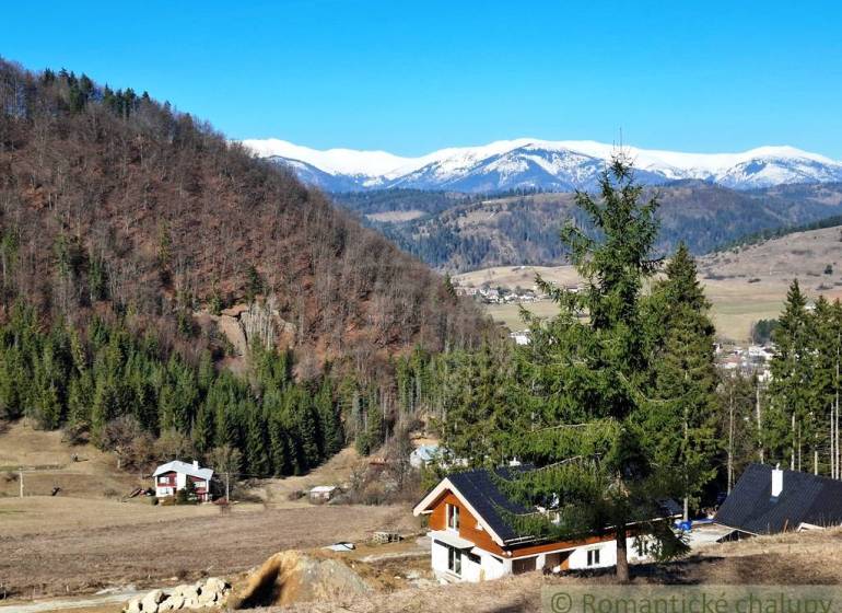 Havas hegyek és kunyhók erdőkkel és mezőgazdasági területekkel körülvéve Hronc közelében.