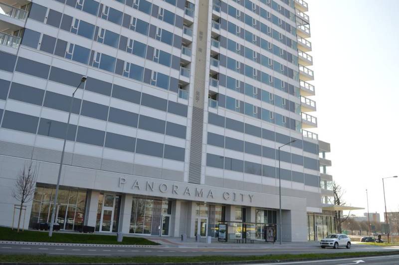 Veľká budova s nápisom Panorama City na ulici Landererova, ponúkajúca 2-izbový byt.