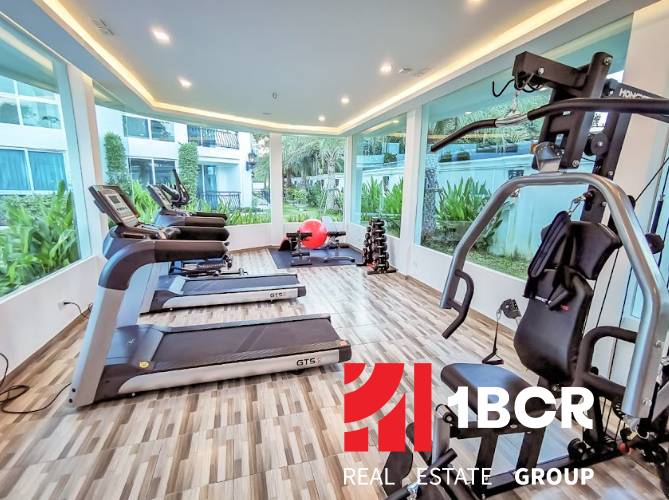 Belső fitneszterem edzőgépekkel lakóépületben.