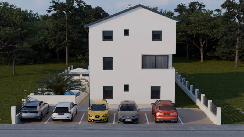Parkoló egy 4 szobás lakásnál Mandrában, öt autóval egy fehér épület előtt.