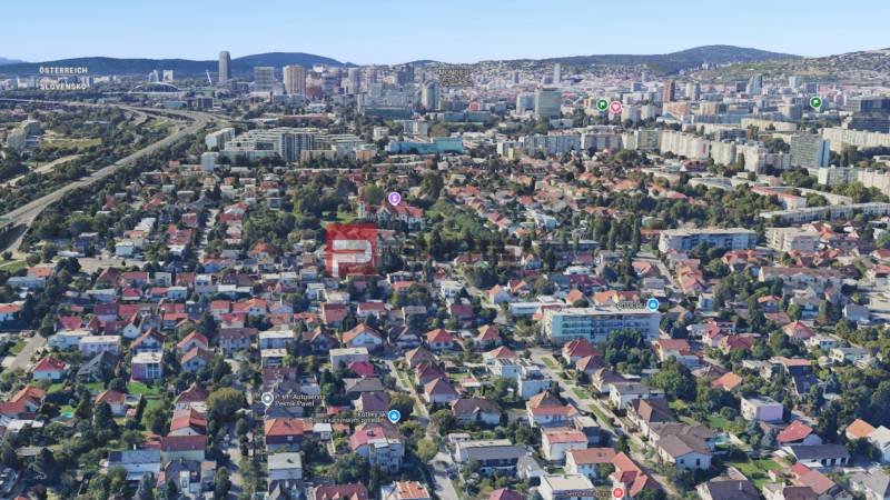Légi felvétel családi házakról Pozsonyban, zöld terület és városi panoráma.