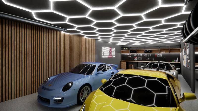 Kereskedelmi helyiségek parkoló sportautókkal és modern mennyezeti világítással.