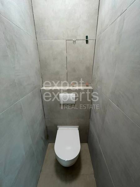 Két szobás lakás fürdőszobai helyiségei WC-vel és csempével.