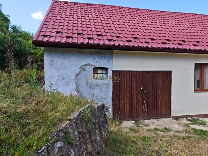 Családi ház Vranov nad Topľou-ban, a Dlhá utcában, piros tetővel és fa garázzsal.