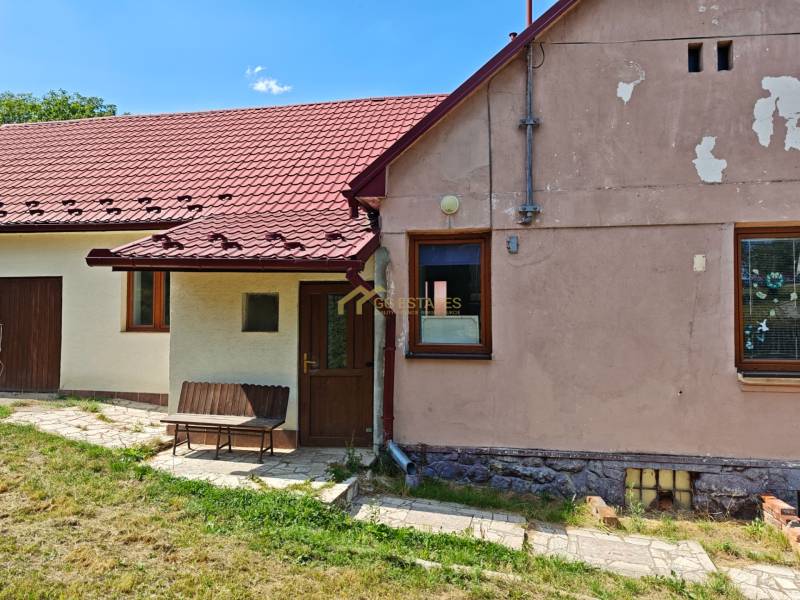 Családi ház a Vranov nad Topľou Dlhá utcáján, piros tetővel és paddal.