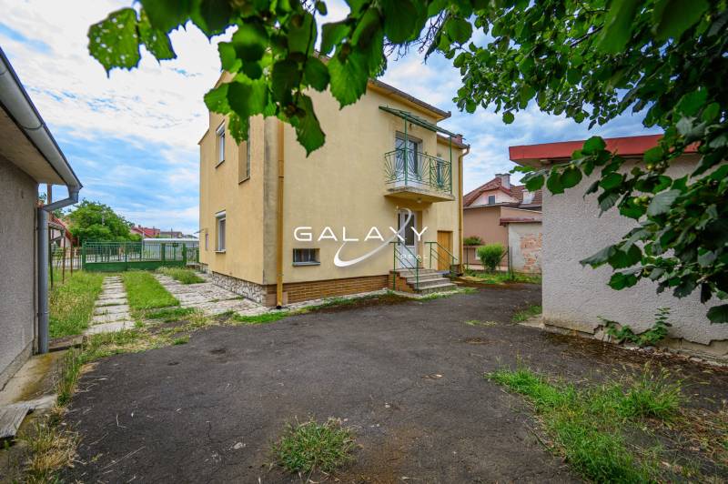 Családi ház Vidinán kerttel, gyepfelülettel és környező épületekkel.