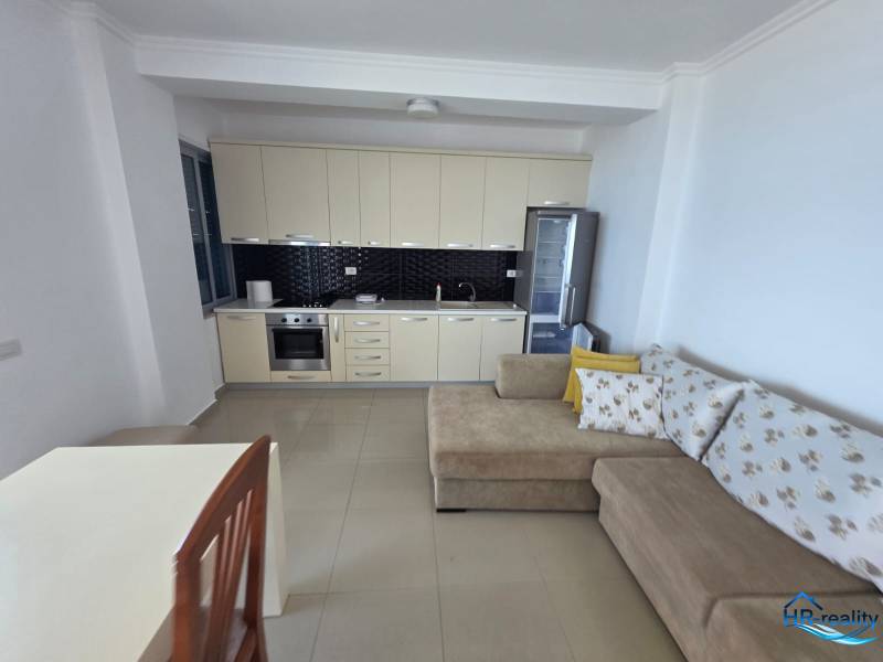 Nyaraló apartman konyhával, kanapéval és étkezőasztallal.