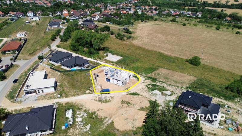 Családi ház építési területe Trencsénjesztrábiban, amelyet természet és szomszédos házak vesznek körül.