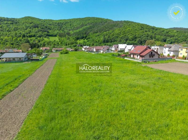 Telkek - lakhatás Udičában zöld rétekkel és vidéki házakkal az erdő közelében.
