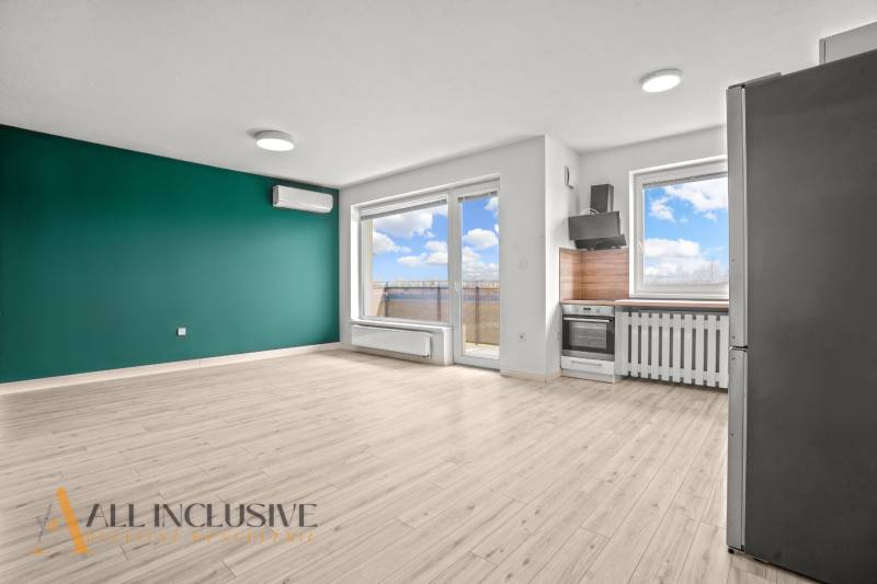 Nappali konyhasarokkal egy kétszobás lakásban, fa dekor padlóval.