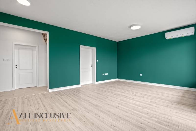 Szoba fa mintás padlóval, zöld falakkal és légkondicionálóval, 2 szobás lakás.