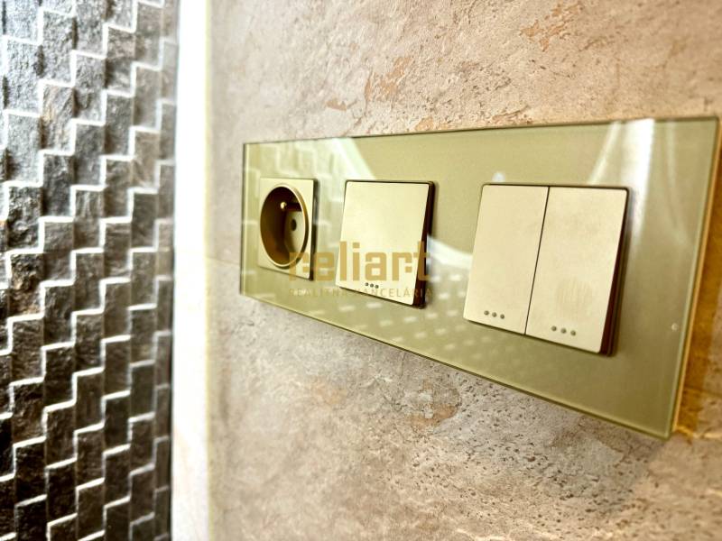 Dugalj és kapcsolók a kőfalon egy háromszobás lakásban.