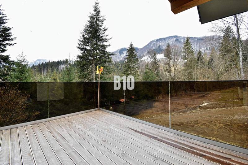 Házikó Terchovában terasszal, kilátással a havas hegyekre és erdőre.