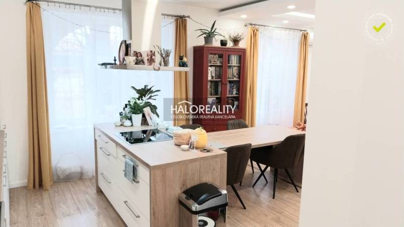 Modern konyha egy háromszobás lakásban, éles vonalakkal és fa dekorációjú padlóval.