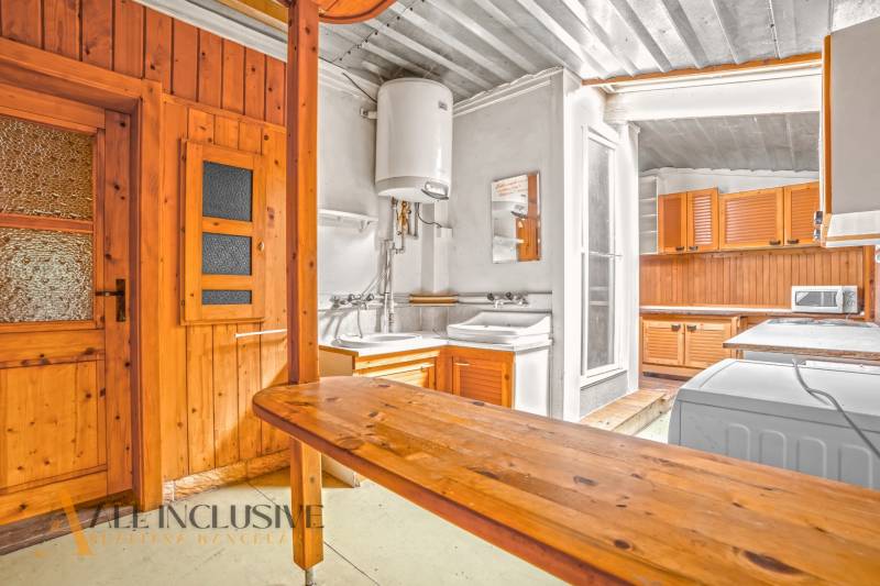 Konyha családi házban fa burkolattal és praktikus felszereléssel.