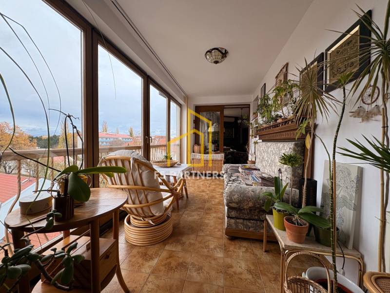 Öt vagy több szobás lakás télikertjének belső fotója sok növénnyel.