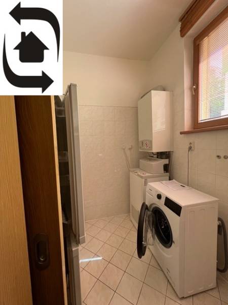 Mosókonyha egy 4 szobás lakásban mosógéppel, szárítógéppel és kazánnal, világos csempével.