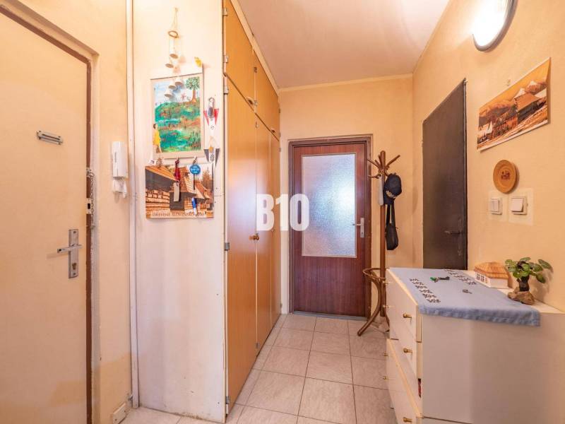 Előszoba egy kétszobás lakásban folyosóval, zárt ajtókkal és tárolóhelyiségekkel.