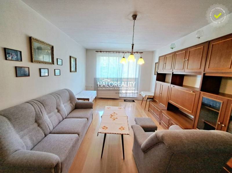 Nappali világítással, fa dekor padlóval és bútorokkal egy háromszobás lakásban.