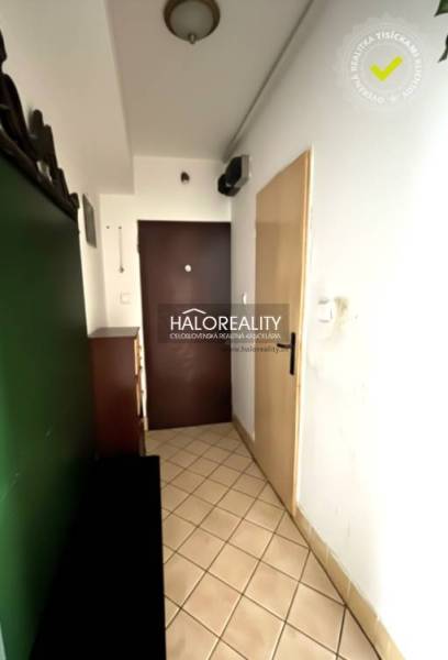 3 szobás lakás előszobája csempével és bútorokkal.