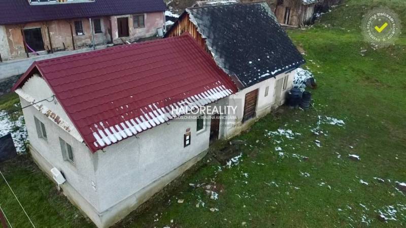 Családi ház Klenócon, nyeregtetővel és havas kerttel.