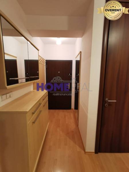 Előszoba egy 2 szobás lakásban fa dekoros padlóval, tükrökkel és szekrényekkel.