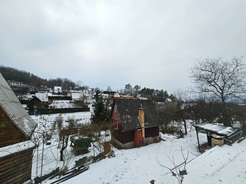 Havas faház Lieskovecben, Dubnica nad Váhom, fákkal és más faházakkal körülvéve.