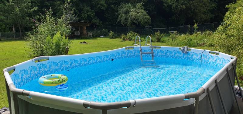 Felfújható medence a nyaraló kertjében, zölddel körülvéve a Tisovec-i Hviezdoslav utcában.