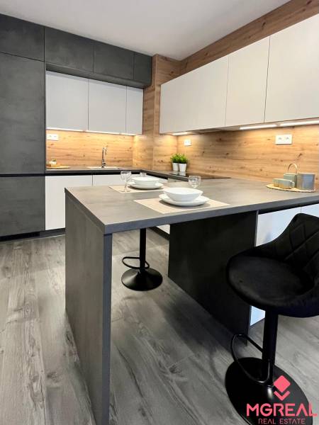 Konyha egy kétszobás lakásban, fa dekor padlóval és modern bútorokkal.