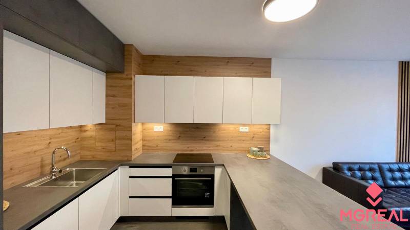 Konyha egy kétszobás lakásban fa dekorációval és kanapéval.