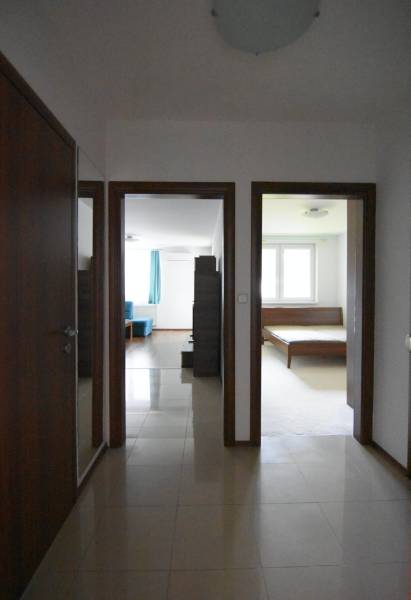 A csempe dekorációjú padlójú folyosó a nappaliba és a kétszobás lakás hálószobájába vezet.