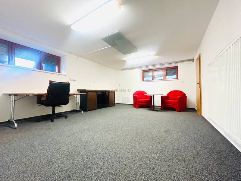 Az irodának a családi házban van szőnyege, íróasztala és piros székei.