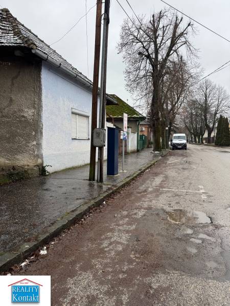 Családi ház a Komenského utcában, Surányban, az út mellett villanyoszloppal és fákkal.