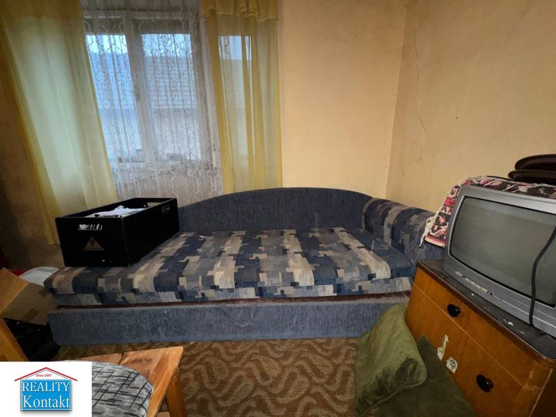 Kanapé és televízió egy családi ház szobájában vintage belső dekorációval.