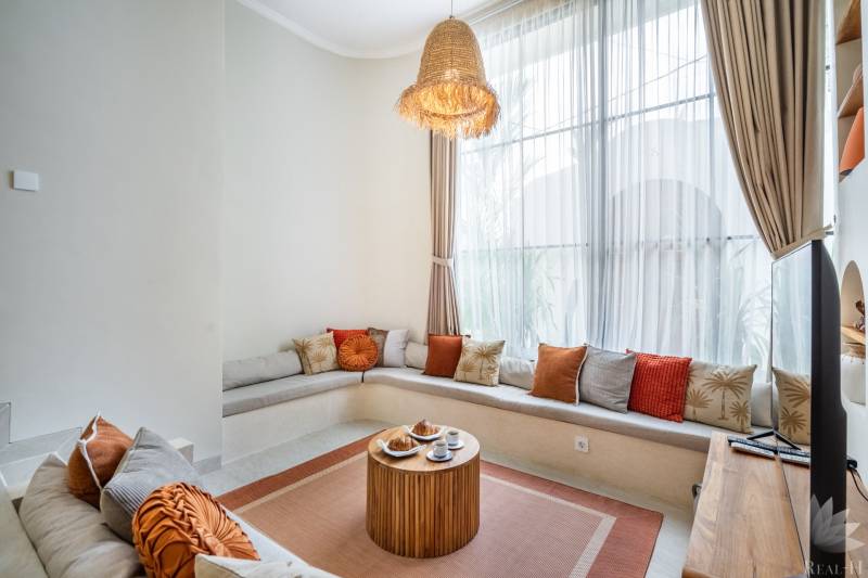 Kényelmes ülőhely párnákkal és egy faasztallal a villa hangulatos sarkában.